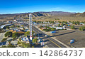 Aerial World's Tallest Thermometer Baker California Desert Townscape and Mountains 142864737