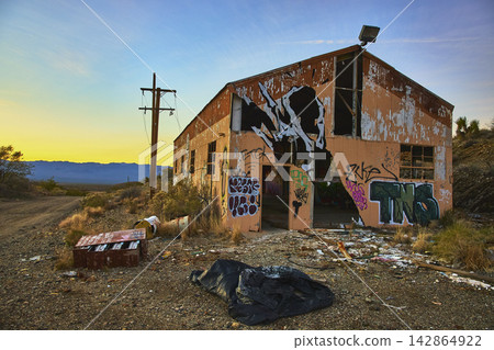 Abandoned Graffiti Covered Building and Desert Landscape at Golden Hour Abandoned Graffiti Covered Building and Desert Landscape at Golden Hour 142864922