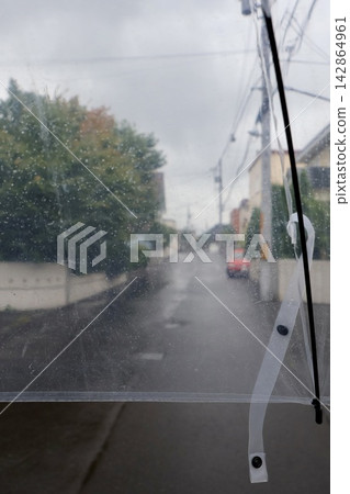 A residential street in Hokkaido, seen through a plastic umbrella in the light rain. A residential street in Hokkaido, seen through a plastic umbrella in the light rain. 142864961