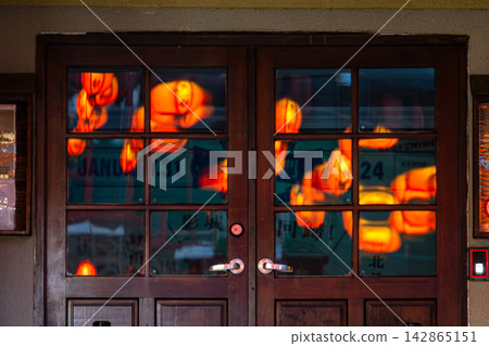 Lantern light and shadow filtering through the wooden window Lantern light and shadow filtering through the wooden window 142865151