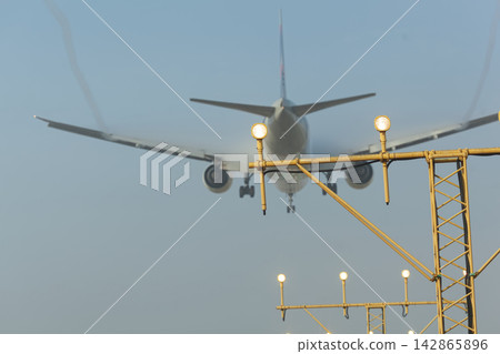 Airplane landing approaching runway lights Airplane landing approaching runway lights 142865896