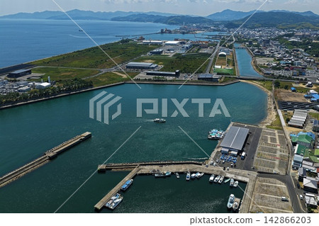 Aerial photograph capturing a fishing port and coastal industrial facilities in Awaji City, Hyogo Prefecture. Aerial photograph capturing a fishing port and coastal industrial facilities in Awaji City, Hyogo Prefecture. 142866203