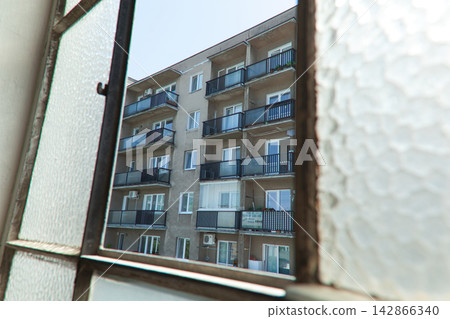 Apartment building view through textured window Apartment building view through textured window 142866340