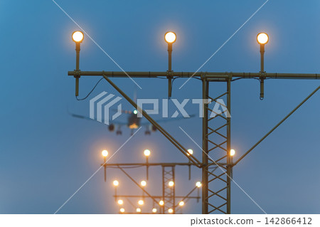 Landing airplane with runway lights Landing airplane with runway lights 142866412