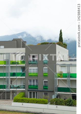 Modern apartment building with green balconies Modern apartment building with green balconies 142866413