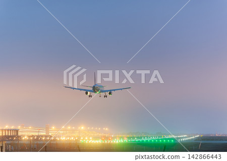 Airplane landing on illuminated runway Airplane landing on illuminated runway 142866443