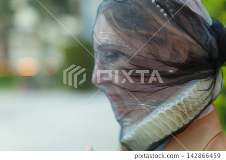 Portrait of person with black veil Portrait of person with black veil 142866459