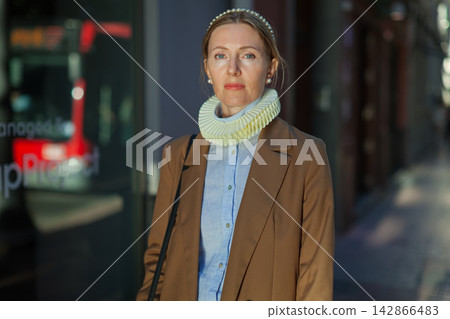 Woman wearing ruffled collar outdoors 142866483