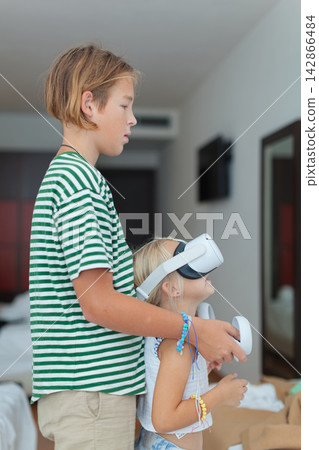 Children using virtual reality headset indoors Children using virtual reality headset indoors 142866484