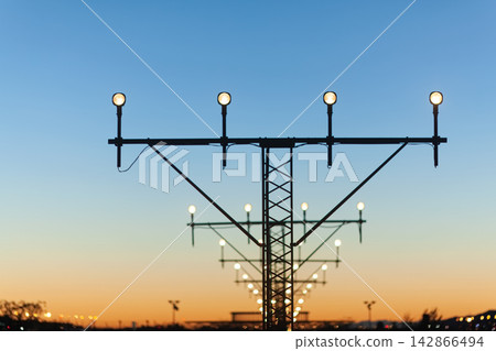 Airport runway lights at sunset Airport runway lights at sunset 142866494