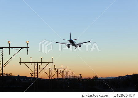 Airplane landing at sunset Airplane landing at sunset 142866497