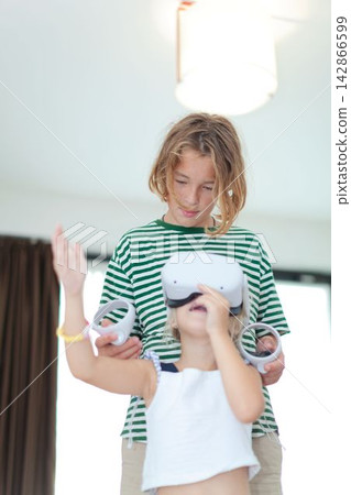 Children playing with virtual reality headset Children playing with virtual reality headset 142866599