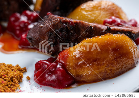 Caramelized pear with duck and lingonberry sauce close detail 142866685