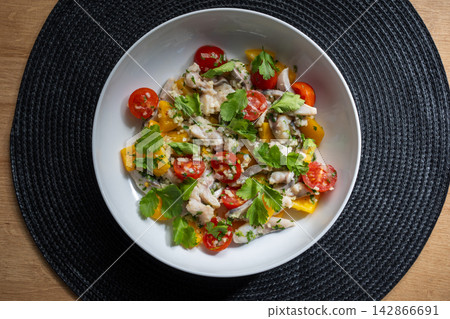 Ceviche in white bowl overhead with wooden table background Ceviche in white bowl overhead with wooden table background 142866691