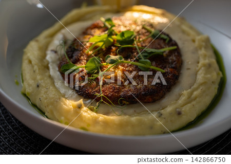 Meat kotlet bowl side view on dark placemat and background 142866750