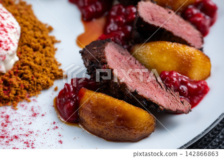 Duck breast and caramelized pear close side with crumble element Duck breast and caramelized pear close side with crumble element 142866863