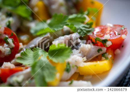 Ceviche close view with yellow pepper cilantro leaf and fish 142866879