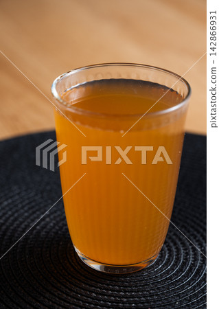 Fruit compote on dark placemat with wooden table background Fruit compote on dark placemat with wooden table background 142866931