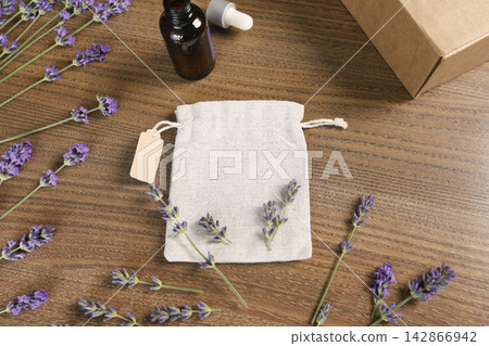 Handmade organic lavender spa cosmetic set with natural sachet bag on wood. Cozy home wellness gift box aromatherapy merchandise presentation backdrop. Minimalist rustic lifestyle branding mockup elem Handmade organic lavender spa cosmetic set with natural sachet bag on wood. Cozy home wellness gift box aromatherapy merchandise presentation backdrop. Minimalist rustic lifestyle branding mockup elem 142866942