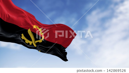 Close-up of Angola national flag waving in the wind on a clear day Close-up of Angola national flag waving in the wind on a clear day 142869526