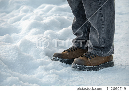Winter boots walking on snow close up Winter boots walking on snow close up 142869749