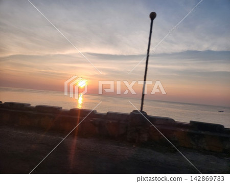 A quiet evening from the breakwater lined with streetlights. A quiet evening from the breakwater lined with streetlights. 142869783