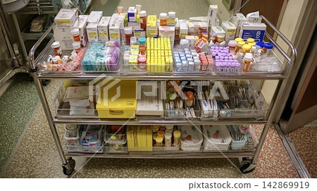 Hospital medical cart holding various medications and supplies Hospital medical cart holding various medications and supplies 142869919