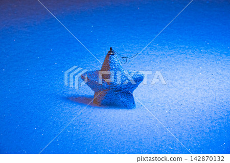 Star decoration in blue winter light Star decoration in blue winter light 142870132