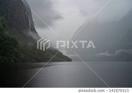 A fjord shrouded in mist, Gudvangen, Norway. A fjord shrouded in mist, Gudvangen, Norway. 142870323