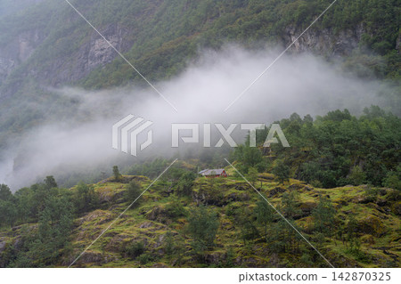 A fjord shrouded in mist, Gudvangen, Norway. 142870325