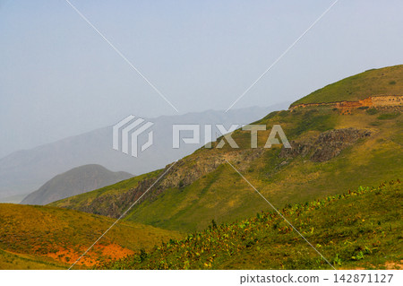 Expansive Mountain Landscape with Rolling Green Hills in Kyrgyzstan 142871127