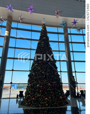 Large Christmas tree and holiday decorations in an airport Large Christmas tree and holiday decorations in an airport 142871460