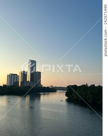 Austin city skyline and river with a rower at sunrise, Texas Austin city skyline and river with a rower at sunrise, Texas 142871490