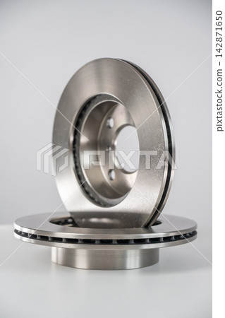 A close-up of new brake discs on a white background. A close-up of new brake discs on a white background. 142871650