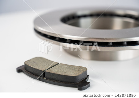 A close-up of new brake discs on a white background. A close-up of new brake discs on a white background. 142871880