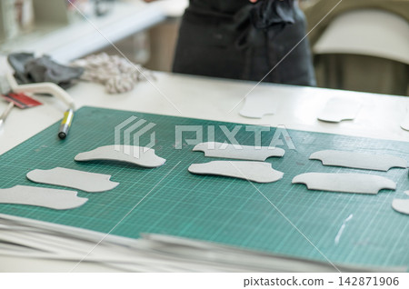 Leatherworker's workbench. Making leather belts. Leatherworker's workbench. Making leather belts. 142871906