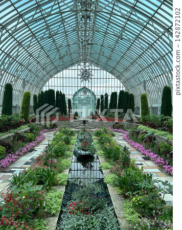 Elegant Glass Conservatory with Lush Gardens, Reflecting Pool, and Statue Elegant Glass Conservatory with Lush Gardens, Reflecting Pool, and Statue 142872102