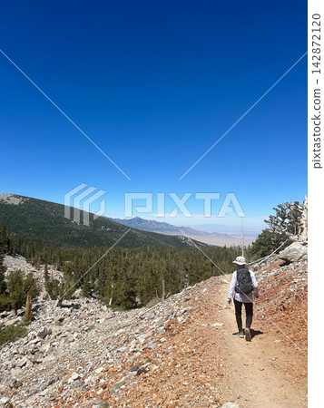 Man hiking on mountain trail in Great Basin National Park Man hiking on mountain trail in Great Basin National Park 142872120