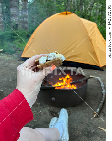 Woman holding smore by campfire at Big Creek Campground, Washington Woman holding smore by campfire at Big Creek Campground, Washington 142872395