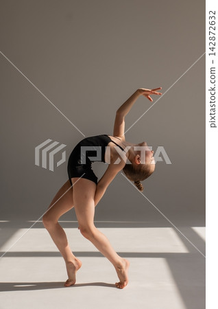 Little gymnast posing on a white background. Little gymnast posing on a white background. 142872632