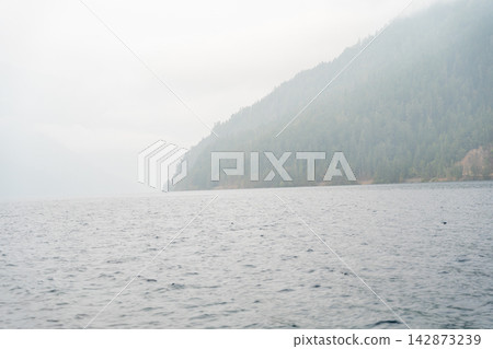 Views of Lake Crescent on a rainy and foggy day in moody Washington state. Views of Lake Crescent on a rainy and foggy day in moody Washington state. 142873239