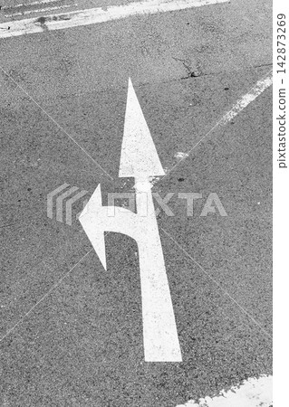 White directional arrow marking straight and left turn urban traffic 142873269