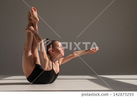 Little gymnast posing on a white background. Little gymnast posing on a white background. 142873293
