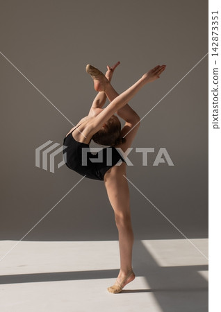 Little gymnast posing on a white background. Little gymnast posing on a white background. 142873351