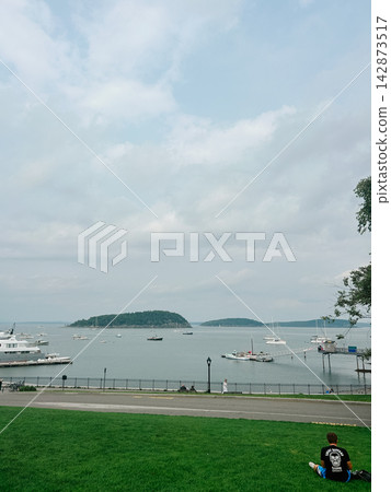 Cloudy waterfront view of boats and islands in scenic Bar Harbor, Maine coast 142873517