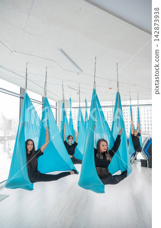 Group yoga class on hammocks. Group yoga class on hammocks. 142873938