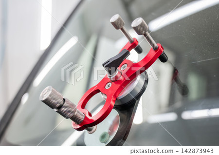 Repairing a chip on a car windshield. Repairing a chip on a car windshield. 142873943