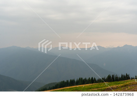 A stunning view of mountains on a rainy day from atop Hurricane Ridge. A stunning view of mountains on a rainy day from atop Hurricane Ridge. 142873968