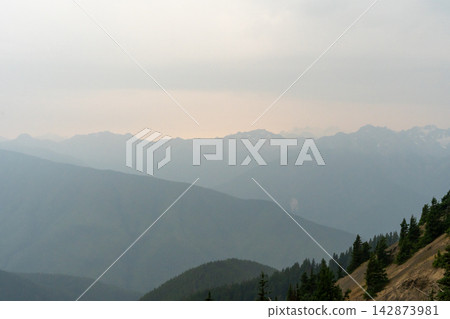 A stunning view of mountains on a rainy day from atop Hurricane Ridge. A stunning view of mountains on a rainy day from atop Hurricane Ridge. 142873981