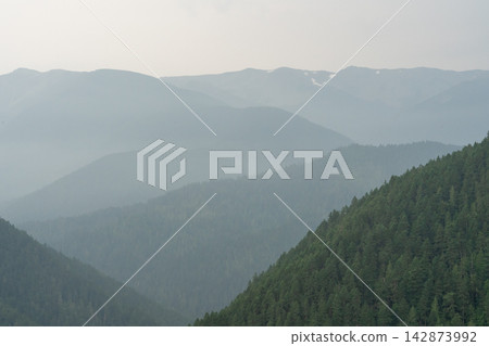 A stunning view of mountains on a rainy day from atop Hurricane Ridge. A stunning view of mountains on a rainy day from atop Hurricane Ridge. 142873992
